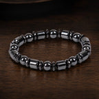Hematite bracelet with polished black gemstone beads on wood surface creating versatile luxury appeal