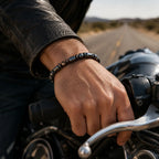 Hematite bracelet paired with rugged motorcycle fashion creating strong gemstone accessory character