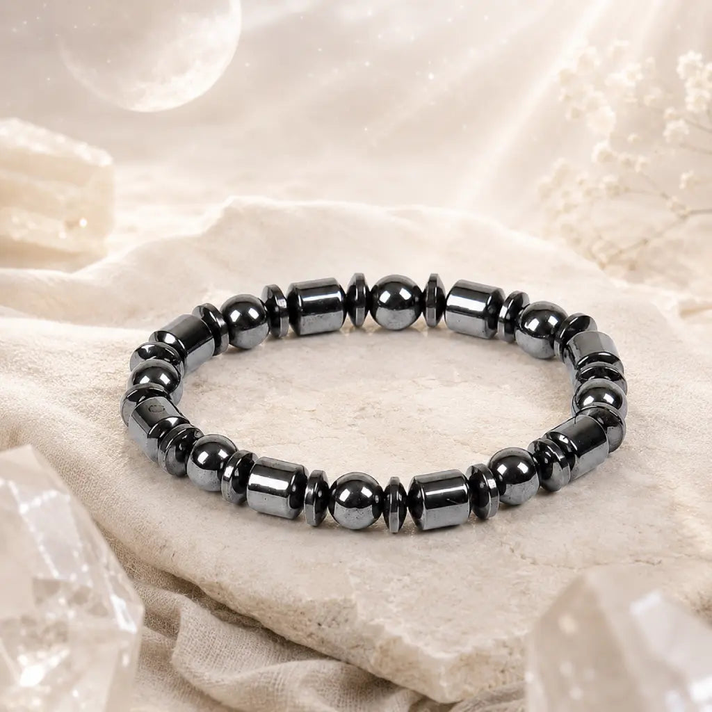 Hematite bracelet with dark polished beads in spiritual setting, healing crystal jewelry for calming energy