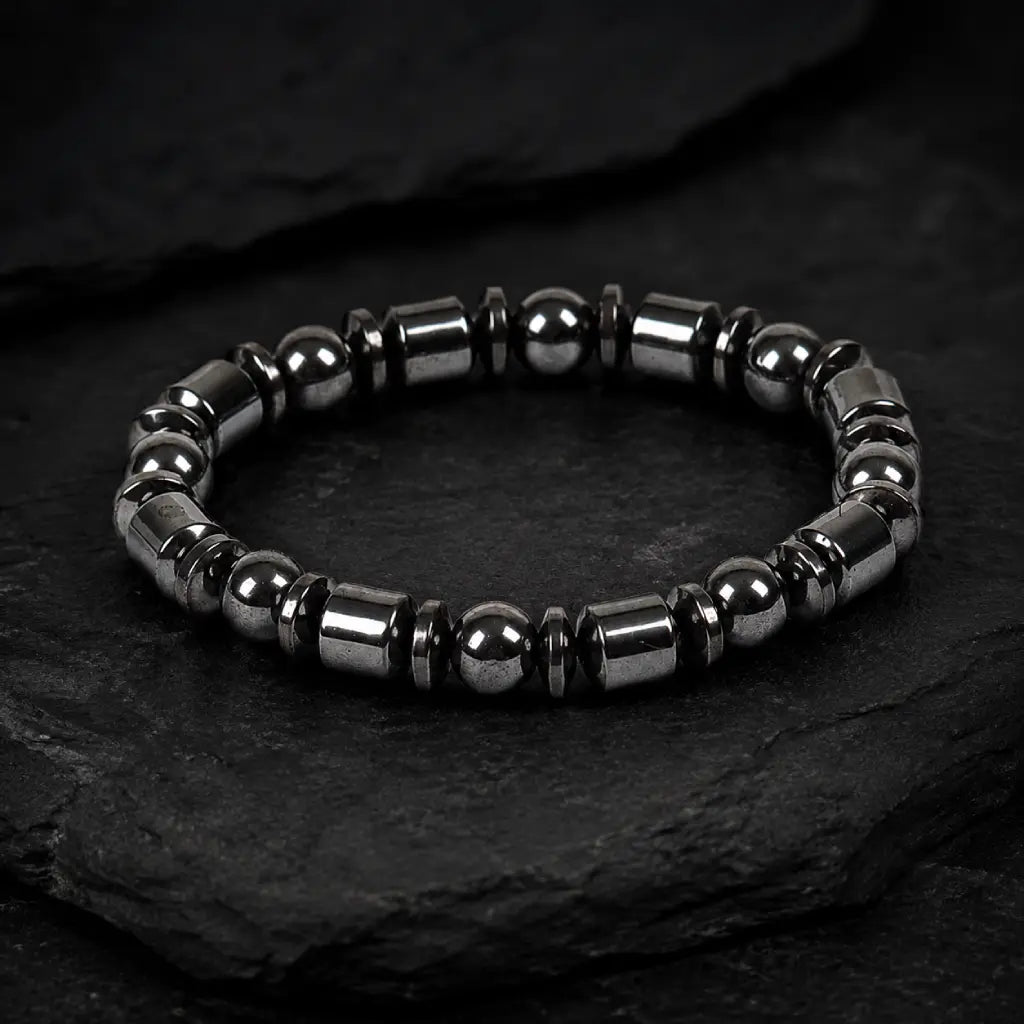 Hematite bracelet featuring glossy black gemstone beads on textured stone for refined everyday fashion wear