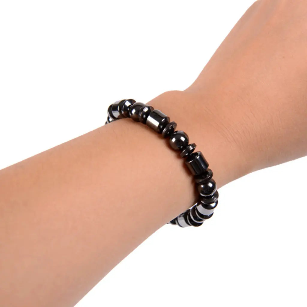 Hematite bracelet featuring sleek black stone beads on wrist, healing crystal accessory for everyday comfort