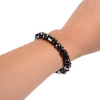 Hematite bracelet featuring sleek black stone beads on wrist, healing crystal accessory for everyday comfort