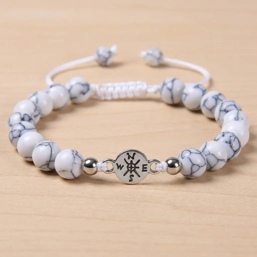 Howlite bracelet with polished white beads and silver charm centerpiece for timeless crystal jewelry style