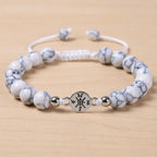 Howlite bracelet with polished white beads and silver charm centerpiece for timeless crystal jewelry style