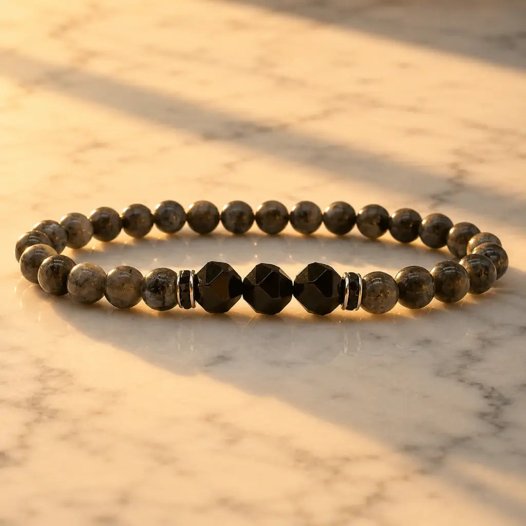 Labradorite and Obsidian bracelet illuminated by golden light for premium crystal jewelry styling inspiration.