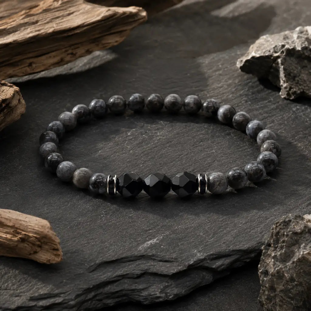 Labradorite and Obsidian bracelet displayed on natural slate with grounding gemstone energy aesthetic style.