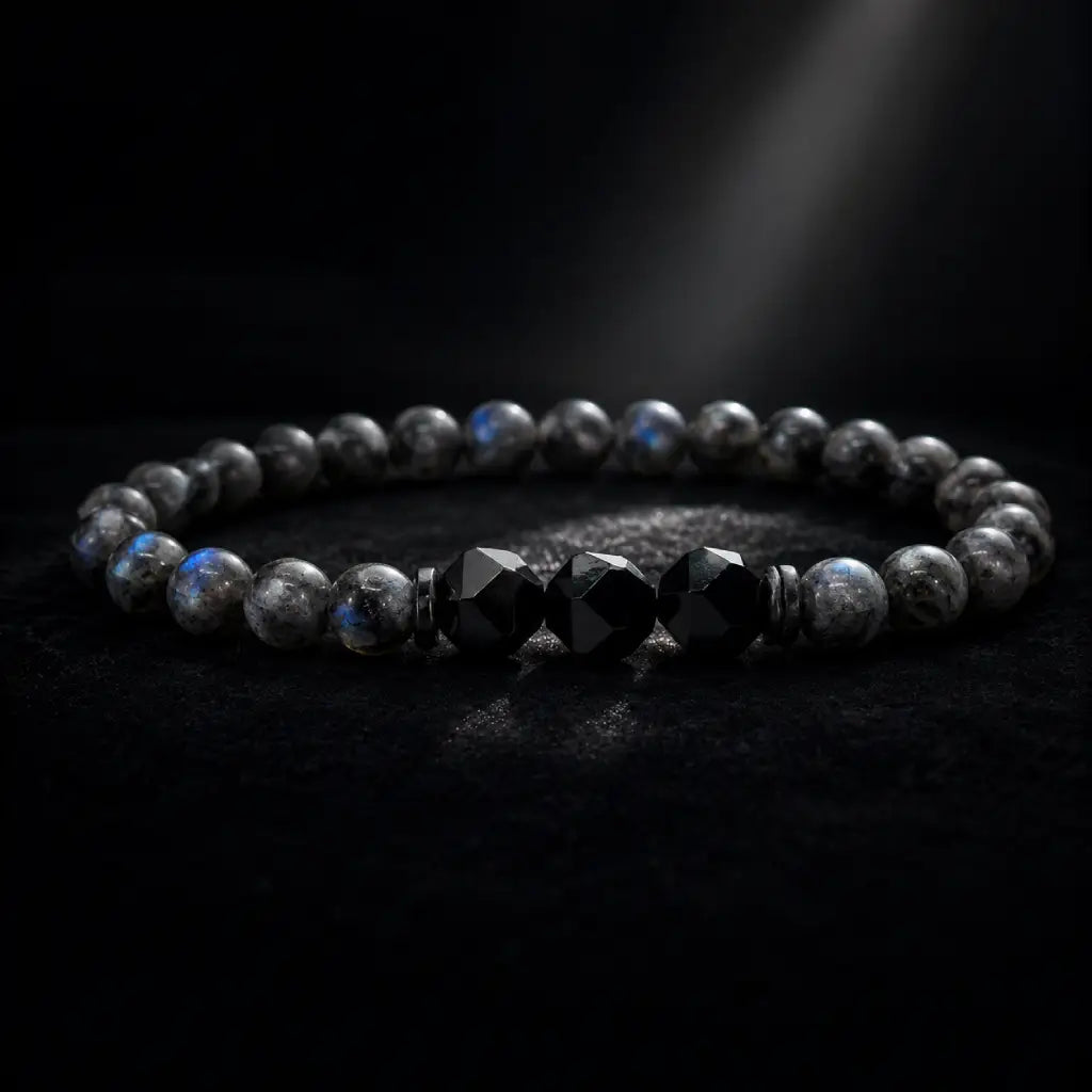 Labradorite and Obsidian bracelet with luminous gemstone beads under spotlight for bold modern energy wear.