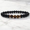 Labradorite and tiger eye bracelet on white marble with polished gemstone beads for sleek modern energy