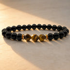 Labradorite and tiger eye bracelet in golden sunlight with glossy black beads for radiant healing style