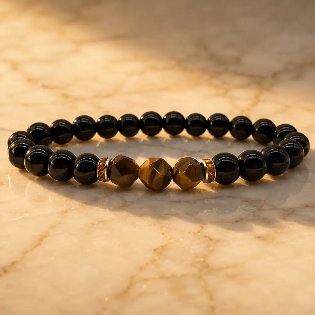 Labradorite and tiger eye bracelet on warm marble with polished black beads for luxury grounding style