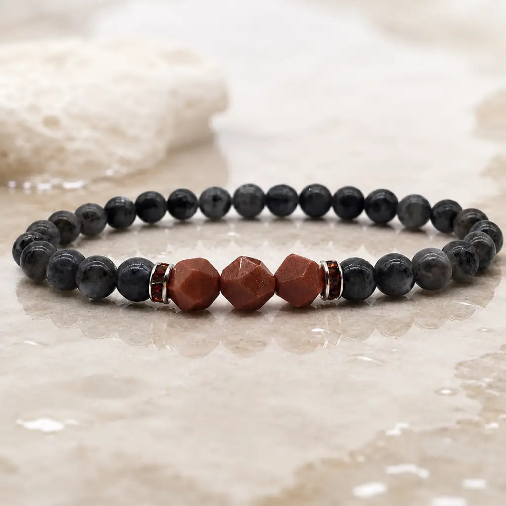 Labradorite crystal bracelet styled with neutral stone textures for elegant mindfulness and grounding protection
