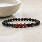 Labradorite crystal bracelet displayed beside ceramic bowl with polished healing beads for calm mindful balance