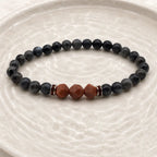 Labradorite crystal bracelet on textured neutral surface featuring grounding gemstone beads for spiritual wellness