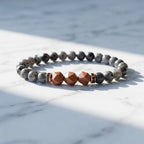 Labradorite crystal bracelet on white marble featuring geometric gemstone accents for mindful daily wear