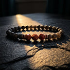 Labradorite crystal bracelet with geometric goldstone beads on dark stone surface for grounding energy balance