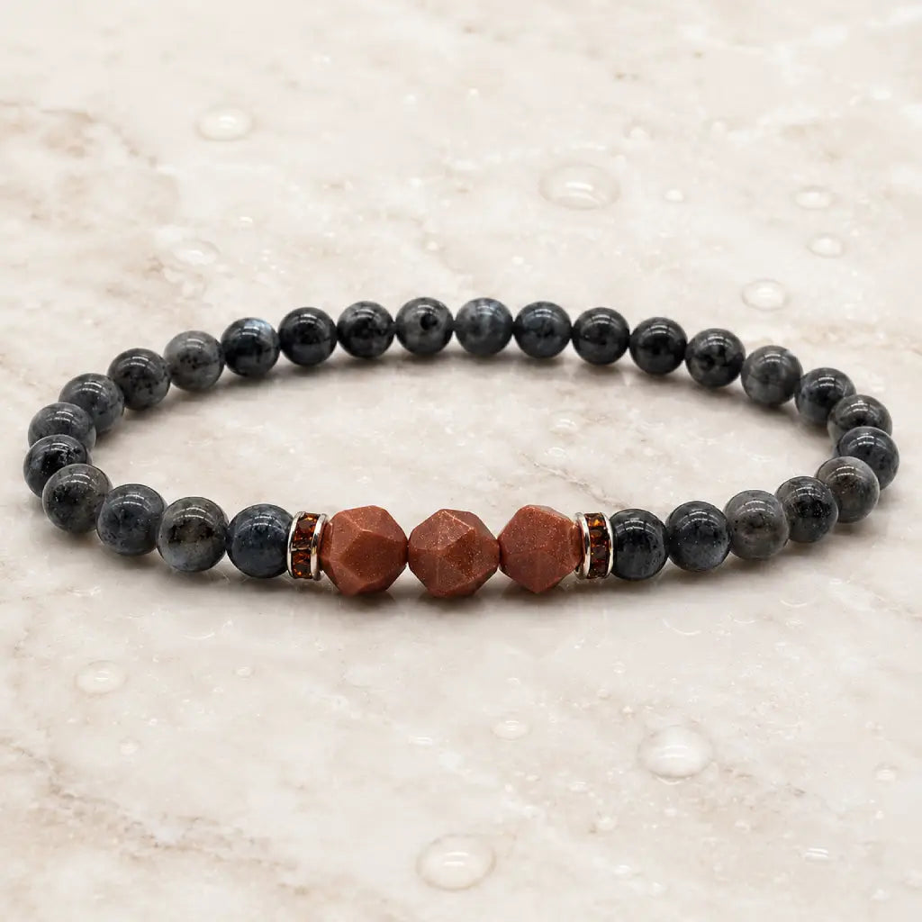 Labradorite crystal bracelet with geometric gemstone beads on marble background for calming spiritual energy