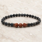 Labradorite crystal bracelet with geometric gemstone beads on marble background for calming spiritual energy