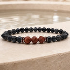 Labradorite crystal bracelet photographed near tranquil water for grounding energy healing and mindful relaxation