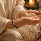 Labradorite dzi bracelet beside healing crystal and candle with matte black beads for peaceful meditation energy