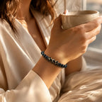 Labradorite dzi bracelet styled with warm tea and soft light, featuring black beads for mindful daily elegance
