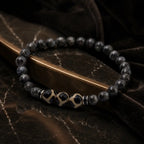 Labradorite dzi bracelet displayed on dark marble with polished black beads for premium healing jewelry style