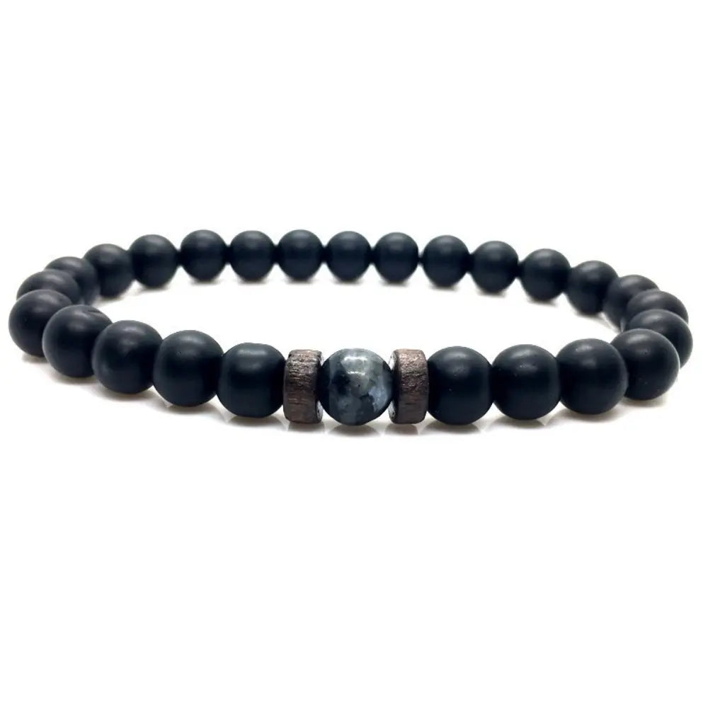 Labradorite handcrafted stretch bracelet with natural gemstone, matte black beads, and wood spacers on a white background.