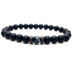 Labradorite handcrafted stretch bracelet with natural gemstone, matte black beads, and wood spacers on a white background.