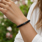 Labradorite healing bracelet with natural gemstone, black matte beads, and wood accents styled for elegant everyday fashion.