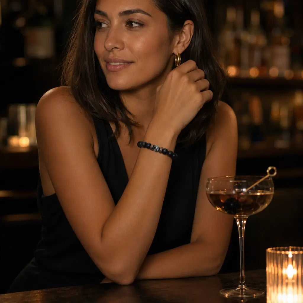 Labradorite gemstone bracelet with matte black beads displayed in an upscale lounge for premium modern jewelry inspiration.
