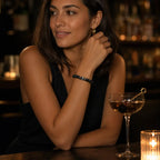 Labradorite gemstone bracelet with matte black beads displayed in an upscale lounge for premium modern jewelry inspiration.