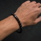 Labradorite minimalist bracelet with matte black beads and authentic gemstone centerpiece styled for timeless men's jewelry.