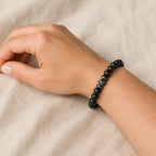 Labradorite minimalist bracelet with matte black beads and authentic gemstone centerpiece displayed for casual everyday wear.
