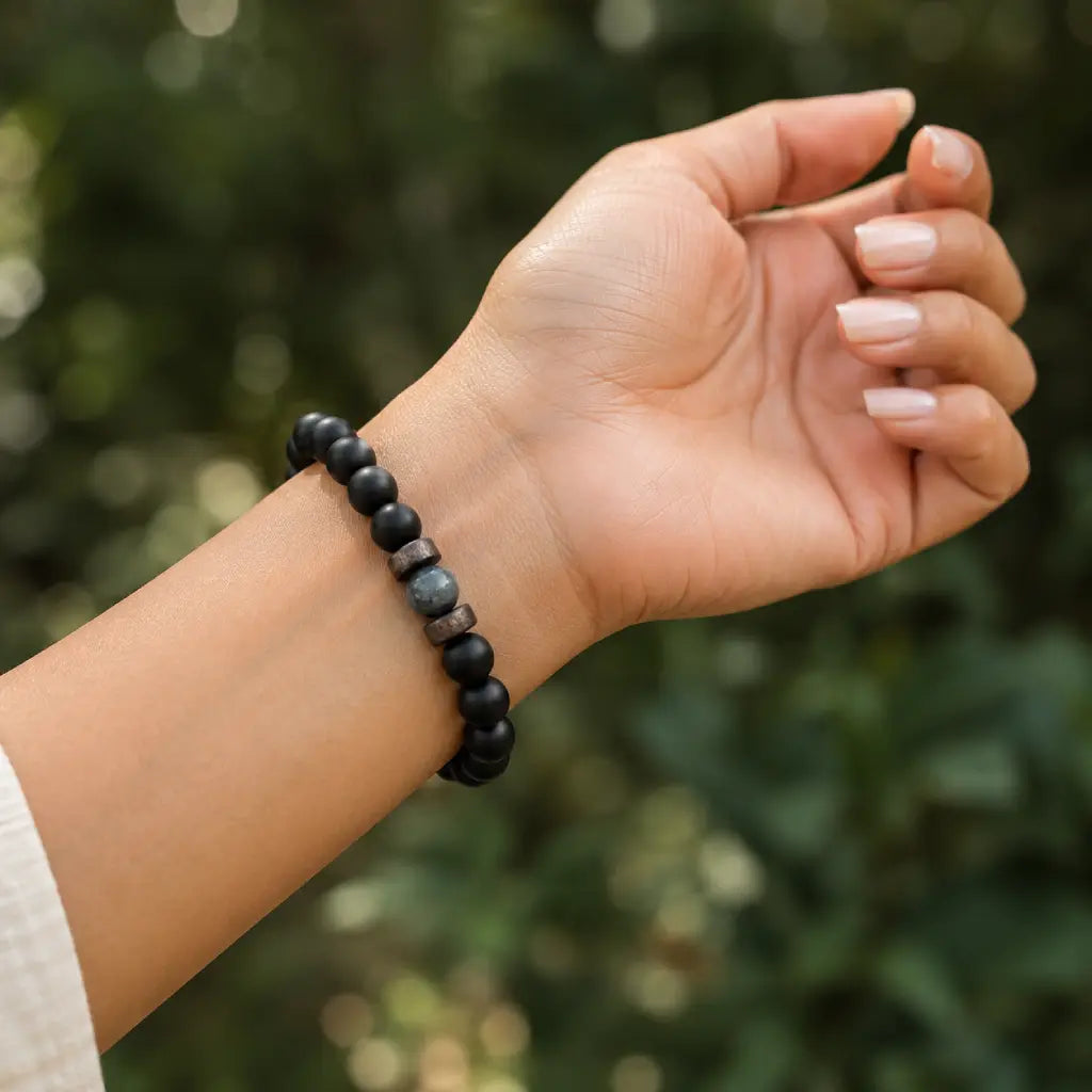 Labradorite stretch bracelet worn outdoors with matte black beads and a genuine labradorite gemstone for modern unisex style.