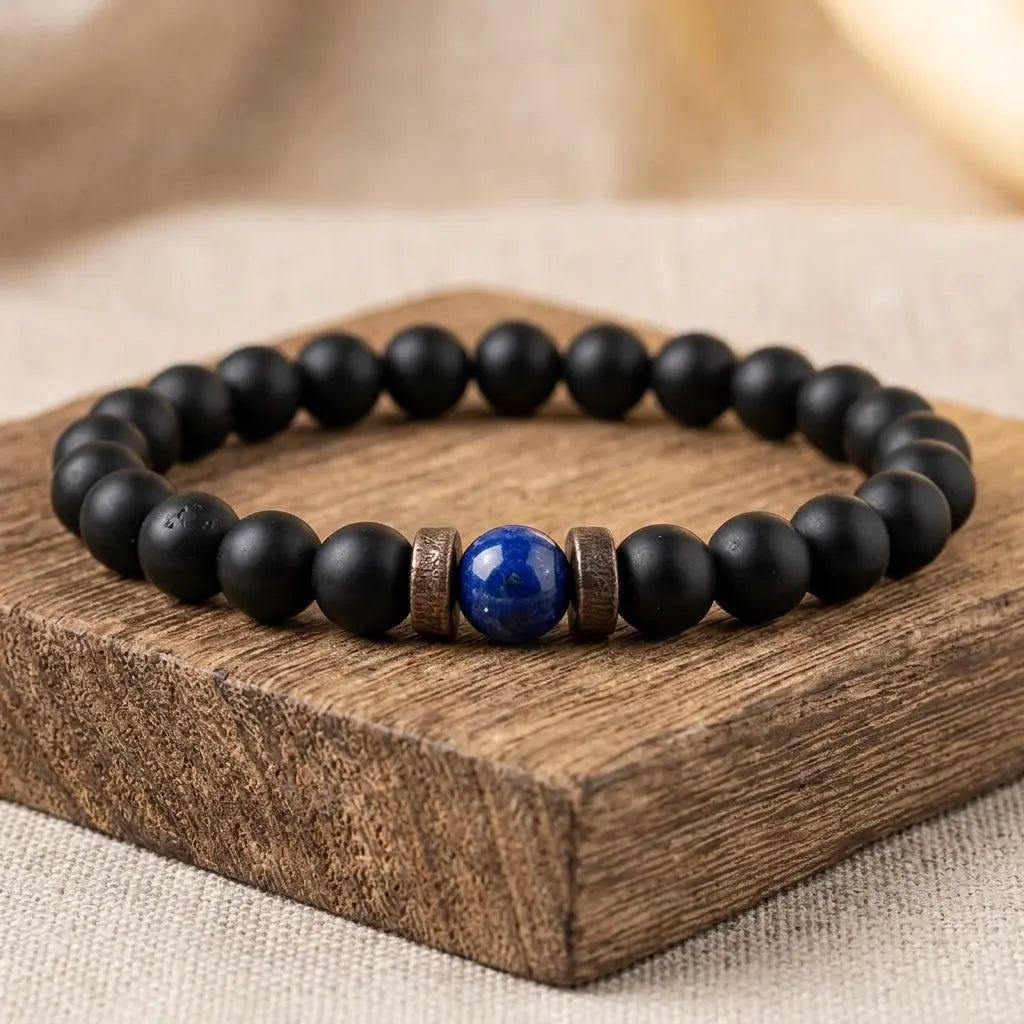 Lapis lazuli and matte black onyx beaded bracelet displayed on dark walnut wood block, premium handcrafted crystal healing gemstone jewelry