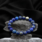 Lapis lazuli bracelet on stone stand with black satin backdrop, premium crystal bead jewelry for bold styling