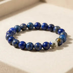 Lapis lazuli bracelet on a soft display cushion, polished blue gemstone jewelry for premium product presentation