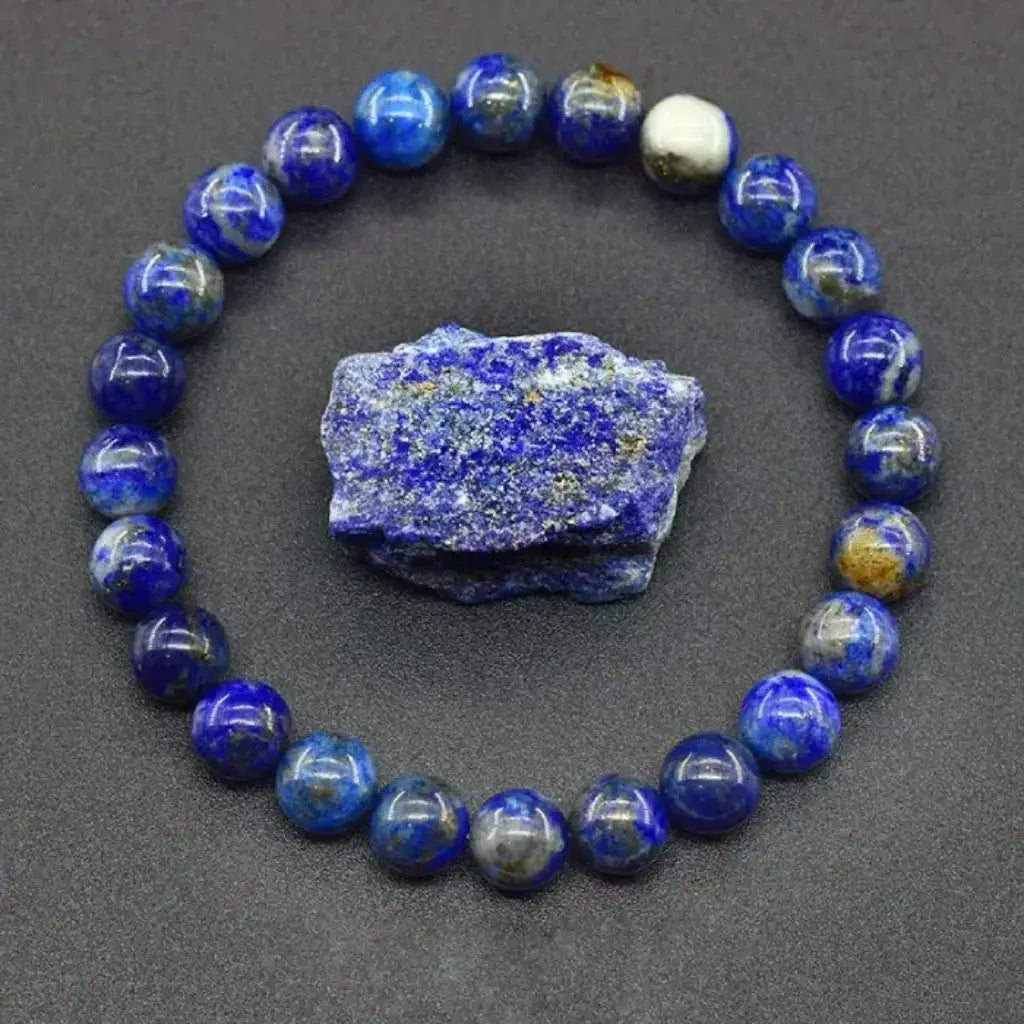Lapis lazuli bracelet with raw gemstone and blue bead circle on black background, polished crystal jewelry display