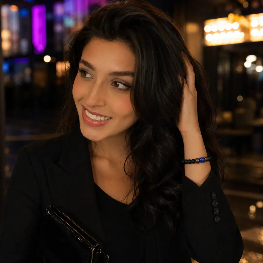 Lapis lazuli black onyx bead bracelet worn by woman in black blazer at upscale city bar, elegant crystal jewelry for women night out