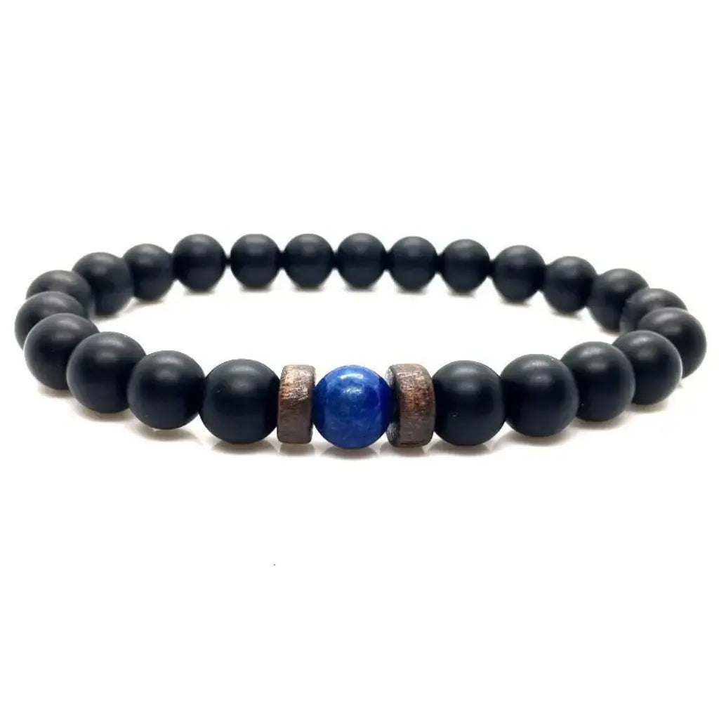 Lapis Lazuli onyx bracelet displayed on a white background with matte black onyx beads, blue lapis lazuli center stone, and spacer accents.