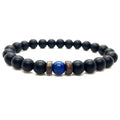 Lapis Lazuli onyx bracelet displayed on a white background with matte black onyx beads, blue lapis lazuli center stone, and spacer accents.