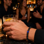 Lapis Lazuli onyx bracelet worn while enjoying cocktails with friends, highlighting matte black onyx beads and a blue lapis lazuli accent.