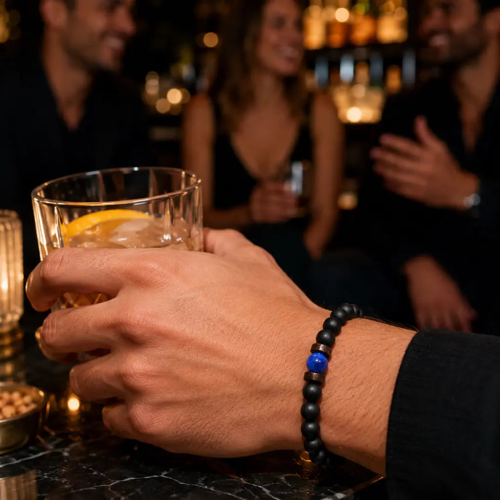 Lapis Lazuli onyx bracelet worn while enjoying cocktails with friends, highlighting matte black onyx beads and a blue lapis lazuli accent.