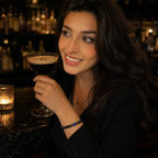 Woman holding a cocktail glass in a bar setting