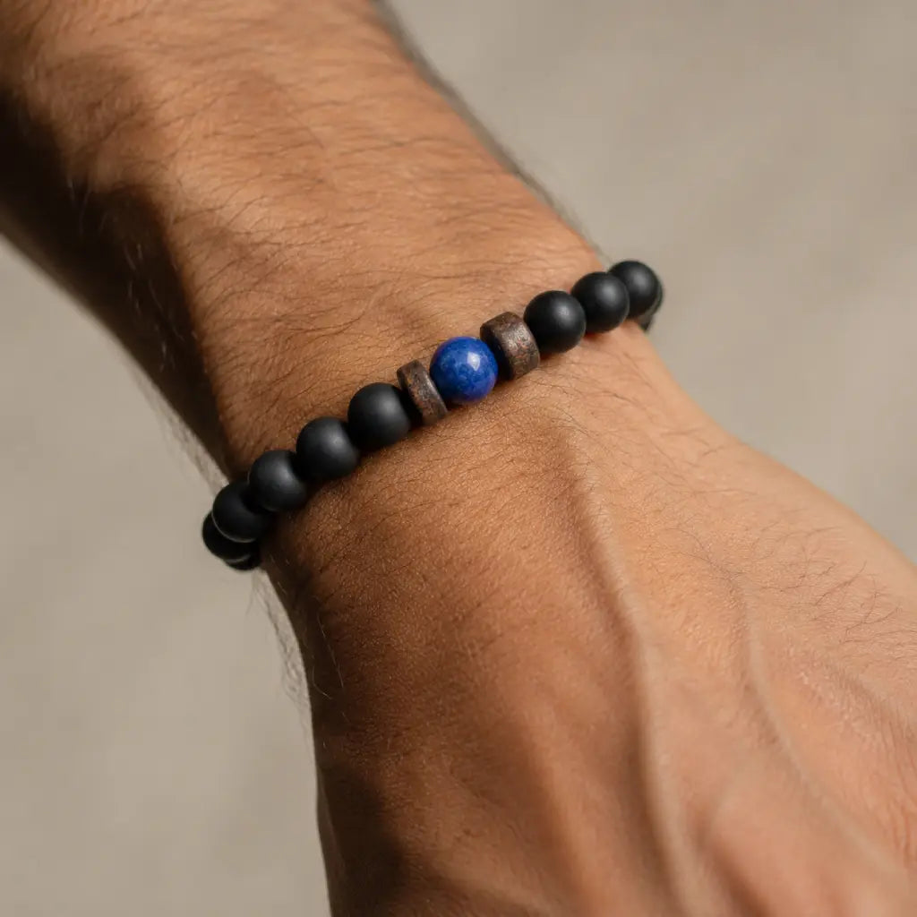 Lapis Lazuli onyx bracelet close-up featuring matte black onyx beads, a polished blue lapis lazuli centerpiece, and textured spacer rings.