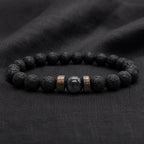Lava labradorite bracelet on dark fabric featuring volcanic rock texture and polished crystal accent for style