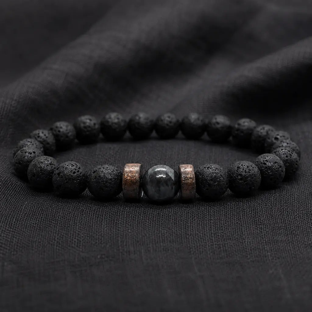 Lava labradorite bracelet on dark fabric featuring volcanic rock texture and polished crystal accent for style