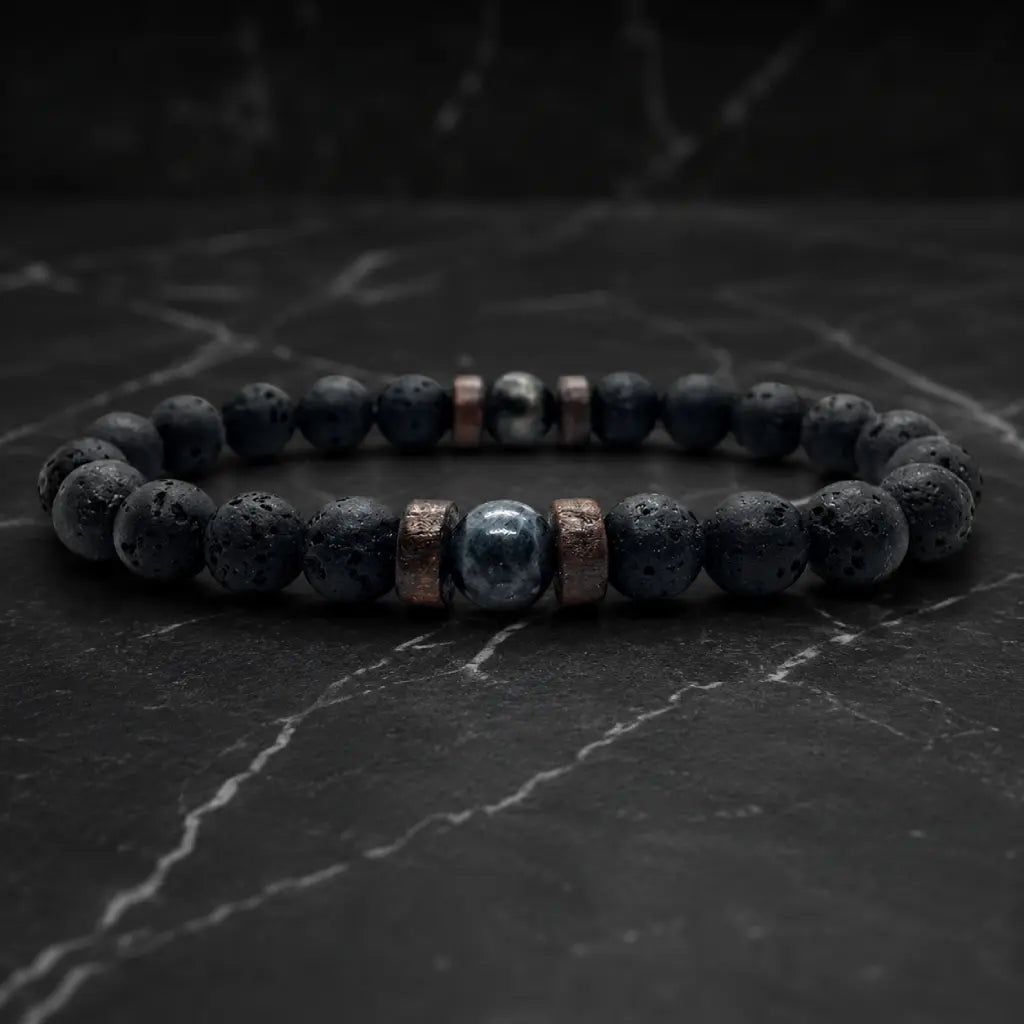 Lava labradorite bracelet displayed on dark marble with volcanic beads and crystal details for grounding energy