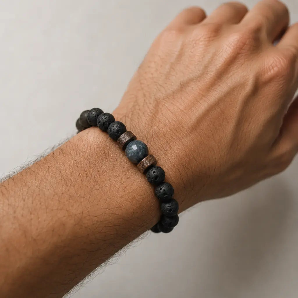 Lava labradorite bracelet styled on wrist featuring natural lava rock beads and polished crystal focal element