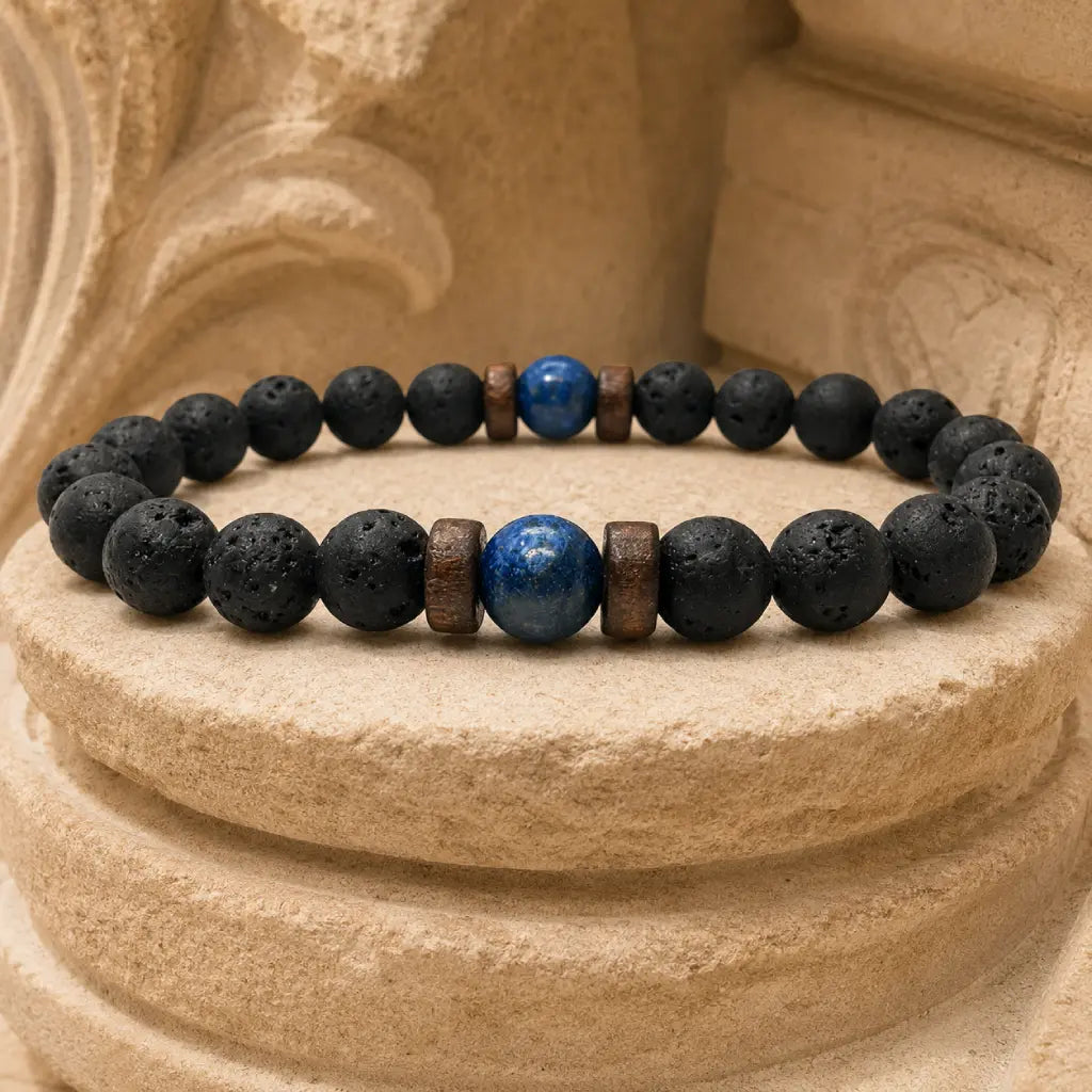 Lava Rock Lapis Lazuli bracelet resting on a stone pedestal with natural lava beads and striking lapis gemstone for timeless men's fashion.