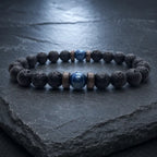 Lava Rock Lapis Lazuli bracelet displayed on dark slate with genuine lava stone beads and vibrant blue lapis centerpiece for modern men's jewelry.